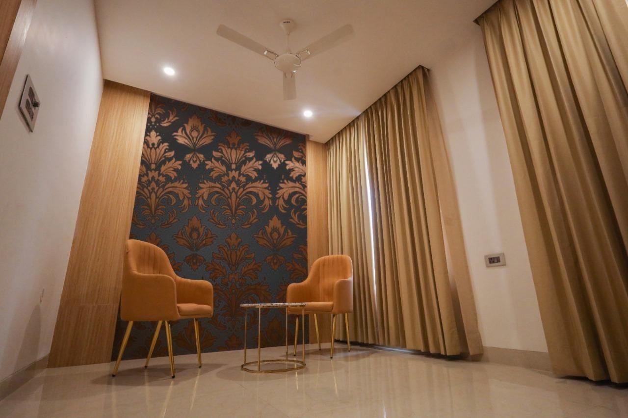 The Royal Legacy Presidential Suite Seating Salon with Damask Wall and Armchairs